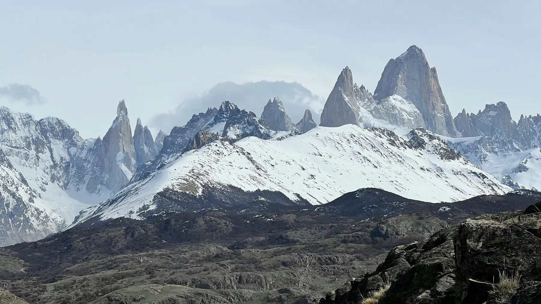 Alpenglow sunrise illuminating the Fitz Roy granite spires in orange light