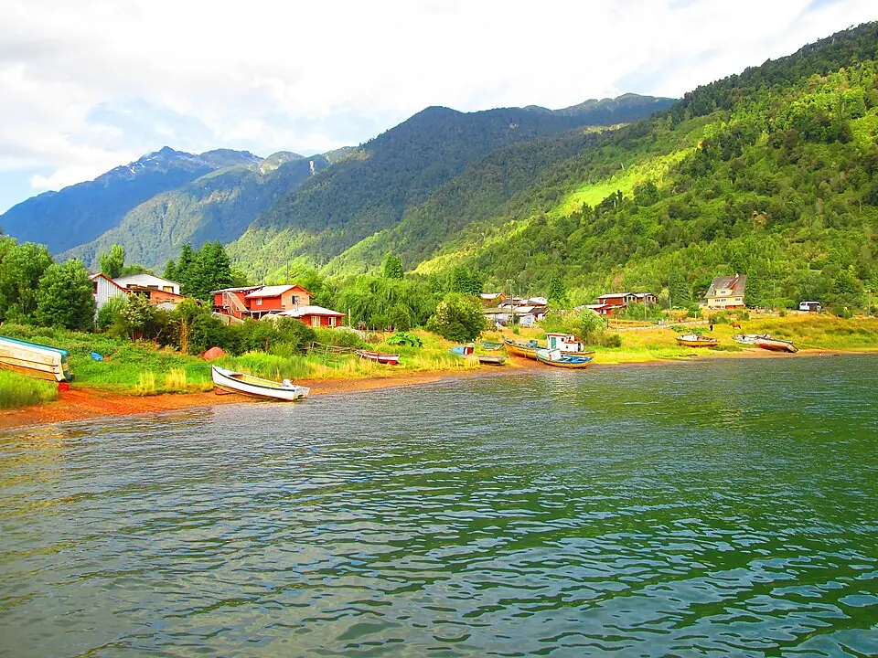 Rainforest-covered mountains rising above the quiet waterfront of Puyuhuapi