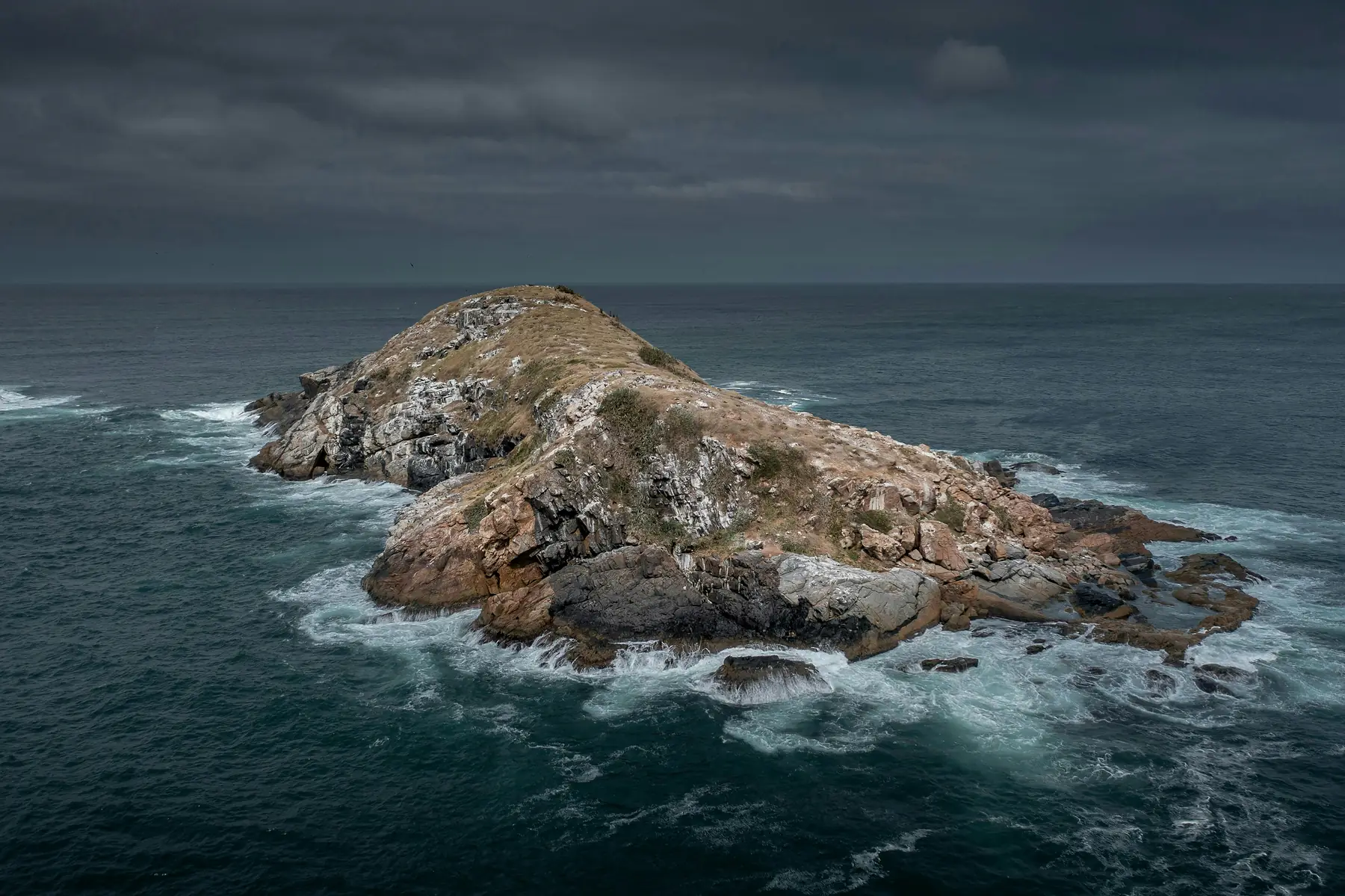 Rocky shores and crashing waves near Cape Horn's Hornos Island