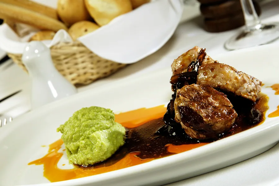 A modern fire-cooked dish representative of Mora Restaurant